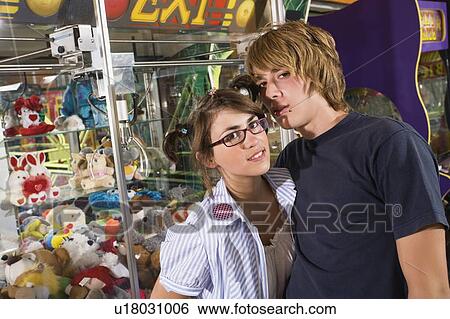 Teenage couple posing in arcade View Large Photo Image Stock Photograph - Teenage couple posing in arcade. Fotosearch