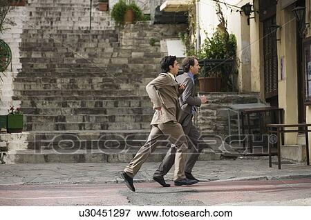 Stock Photo - Two businessmen running. Fotosearch