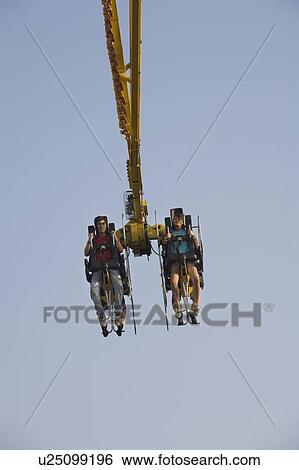 Stock Photograph - Two teenagers on amusement park ride. Fotosearch