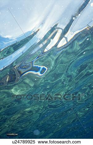Stock Photography - Abstract shot - underside of surface in tropical blue waters. Dominca, Eastern Caribbean.. Fotosearch