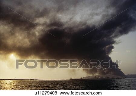 Oil refinery on fire on an island in the Arabian Gulf. United Arab Emirates. View Large Photo Image Stock Photo - Oil refinery on fire on an island in the Arabian Gulf. United Arab Emirates.. Fotosearch
