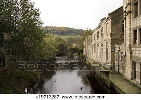 Stock Photo - People feeding the ducks from a bridge. Hebden Bridge, Yorkshire Pennines, UK.. Fotosearch