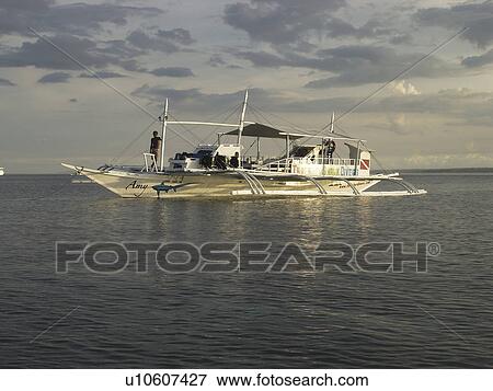 Thresher Shark Divers dive boat catching the early morning sun. malapascua. Philippines View Large Photo Image Stock Photo - Thresher Shark Divers dive boat catching the early morning sun. malapascua. Philippines. Fotosearch