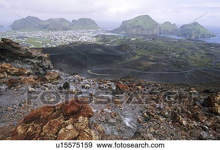 View from the Volcano Eldfell down to the settlement Heimaey. Vestmannaeyjar Islands, Southern Iceland View Large Photo Image Stock Photo - View from the Volcano Eldfell down to the settlement Heimaey. Vestmannaeyjar Islands, Southern Iceland. Fotosearch