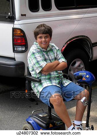 Boy, in electric wheelchair, at Muscular Dystrophy Association Summer Camp. View Large Photo Image Stock Image - Boy, in electric wheelchair, at Muscular Dystrophy Association Summer Camp.. Fotosearch
