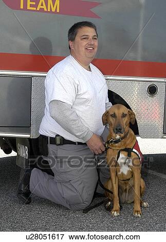 Man poses with rescue dog in front of team truck View Large Photo Image Stock Photo - Man poses with rescue dog in front of team truck. Fotosearch