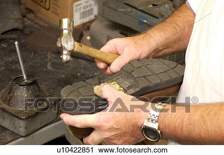 Man repairing a shoe/brace combination used to assist a person with a disability who has mobility impairments. View Large Photo Image Stock Image - Man repairing a shoe/brace combination used to assist a person with a disability who has mobility impairments.. Fotosearch