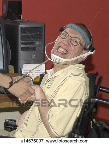 Man with significant disabilities utilizing headgear to operate communications apparatus. View Large Photo Image Stock Photo - Man with significant disabilities utilizing headgear to operate communications apparatus.. Fotosearch
