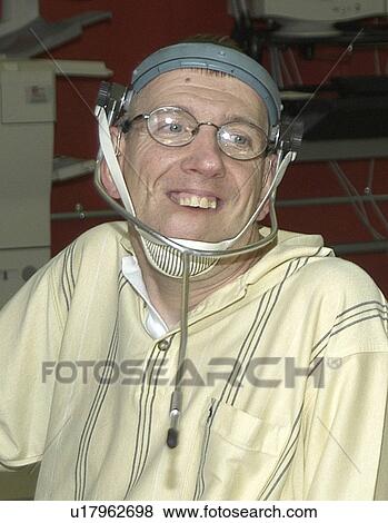 Man with significant disabilities utilizing headgear to operate communications apparatus. View Large Photo Image Stock Photo - Man with significant disabilities utilizing headgear to operate communications apparatus.. Fotosearch