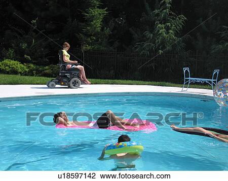 Young woman uses an electric wheelchair to join her family for fun in their accessible pool. View Large Photo Image Stock Image - Young woman uses an electric wheelchair to join her family for fun in their accessible pool.. Fotosearch