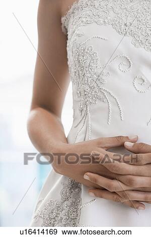 Bride's hands on stomach (focus on hands) View Large Photo Image Stock Photo - Bride's hands on stomach (focus on hands). Fotosearch