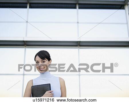 Stock Photograph - Businesswoman holding file (portrait). Fotosearch
