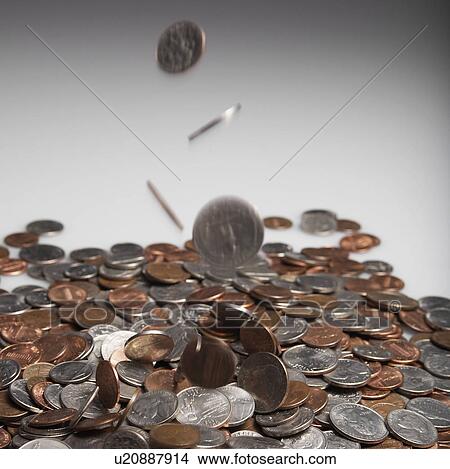 Picture - Coins Falling on Pile. Fotosearch