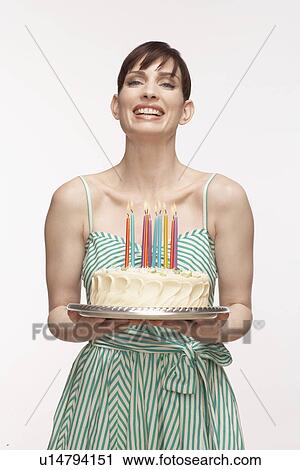 Mid adult woman holding birthday cake View Large Photo Image Stock Image - Mid adult woman holding birthday cake. Fotosearch