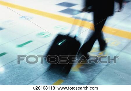 Stock Photo - Person Pulling Suitcase. Fotosearch