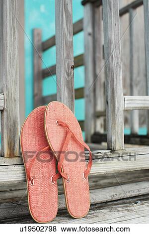 Pink flip flops leaning on fence View Large Photo Image Stock Photo - Pink flip flops leaning on fence. Fotosearch