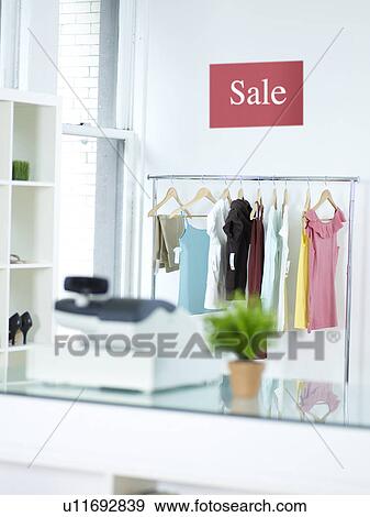 Stock Photo - Sale Sign Above Clothes Rail. Fotosearch