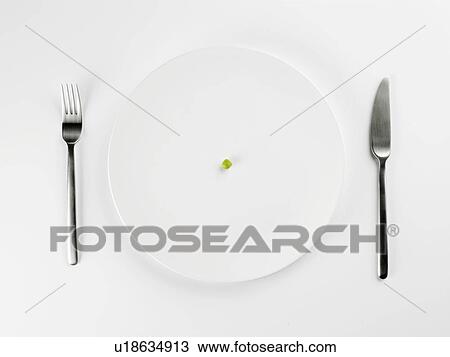 Stock Image - Single pea on white plate (close-up, directly above). Fotosearch
