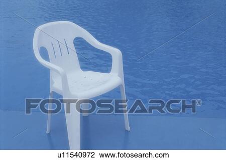 Stock Image - The White Chair At The Poolside. Fotosearch