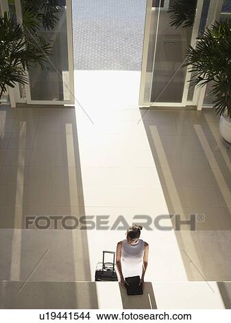 Picture - Woman at hotel reception (high angle view). Fotosearch
