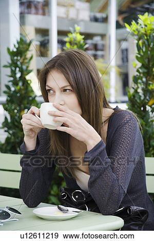 Stock Photo - Young woman drinking coffee. Fotosearch