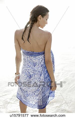 Stock Photo - Young woman in sarong (rear view). Fotosearch