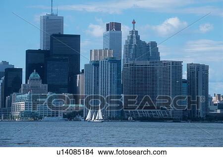 Picture - Boat Sailing Past Skyscrapers. Fotosearch