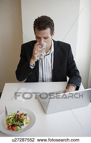 Businessman with laptop eating salad (high angle view) View Large Photo Image Stock Image - Businessman with laptop eating salad (high angle view). Fotosearch