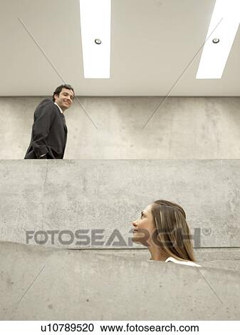 Stock Image - Businesspeople walking (low angle view). Fotosearch