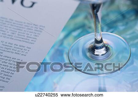 Stock Photography - Glass Near Book Page. Fotosearch