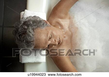 Stock Image - Mature Woman Having Bath. Fotosearch