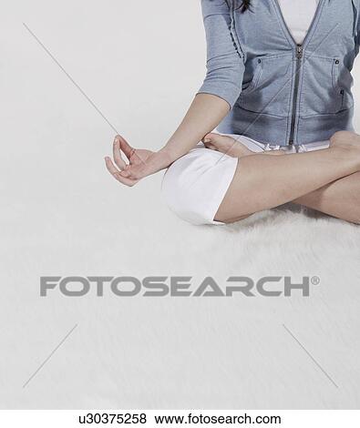 Stock Photo - Mid-Adult Woman Doing Yoga. Fotosearch