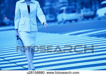 Stock Image - Woman Crossing Street. Fotosearch