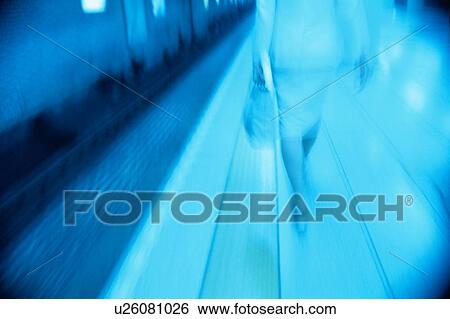 Stock Photograph - Woman Walking On Platform. Fotosearch