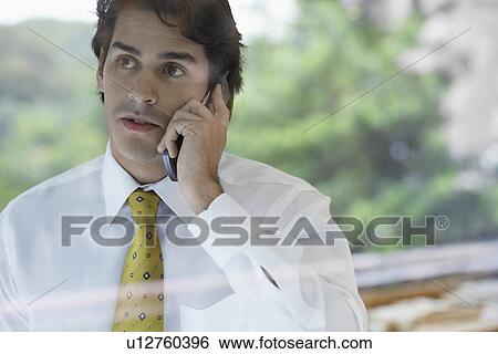 Stock Photograph - Young businessman on phone. Fotosearch