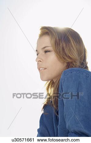 Young woman against clear sky (portrait) View Large Photo Image Stock Image - Young woman against clear sky (portrait). Fotosearch