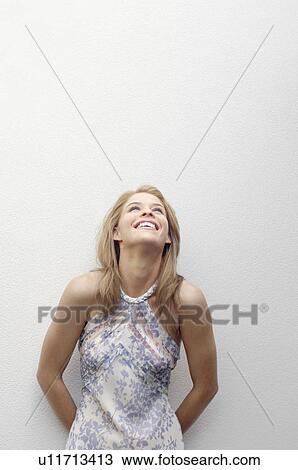 Young woman leaning on wall and laughing (portrait) View Large Photo Image Stock Image - Young woman leaning on wall and laughing (portrait). Fotosearch