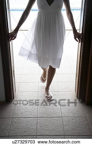 Young woman walking through door (low section) View Large Photo Image Stock Image - Young woman walking through door (low section). Fotosearch