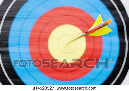 Arrow in bullseye of target (close-up) View Large Photo Image Stock Photo - Arrow in bullseye of target (close-up). Fotosearch