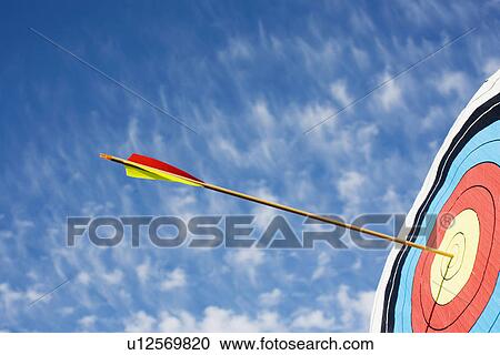 Stock Image - Arrow in bullseye of target. Fotosearch