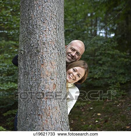 Couple Behind Tree View Large Photo Image Stock Image - Couple Behind Tree. Fotosearch