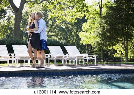 Couple hugging by pool View Large Photo Image Picture - Couple hugging by pool. Fotosearch
