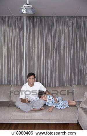 Father and son watching TV View Large Photo Image Stock Photograph - Father and son watching TV. Fotosearch