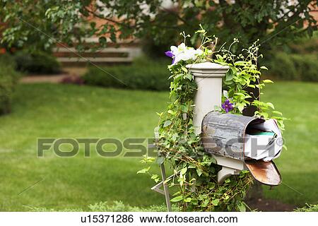 Stock Photograph - Full mailbox in garden. Fotosearch