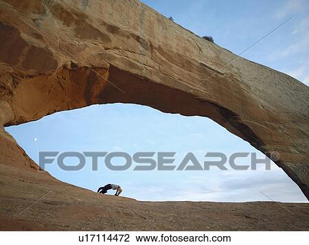 Man doing bridge under arched rock View Large Photo Image Stock Image - Man doing bridge under arched rock. Fotosearch