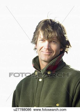 Stock Photograph - Mid adult man in warm jacket, portrait. Fotosearch