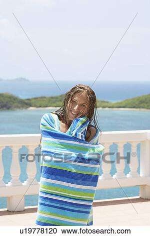 Mid adult woman wrapped in towel View Large Photo Image Stock Image - Mid adult woman wrapped in towel. Fotosearch