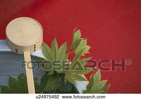 Stock Image - Red Rug And The Wooden Rice Paddle. Fotosearch