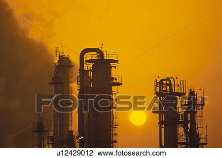 Stock Image - The Setting Sun And A Factory. Fotosearch