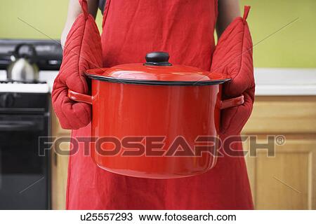 Stock Image - Woman Holding Stew Pot. Fotosearch